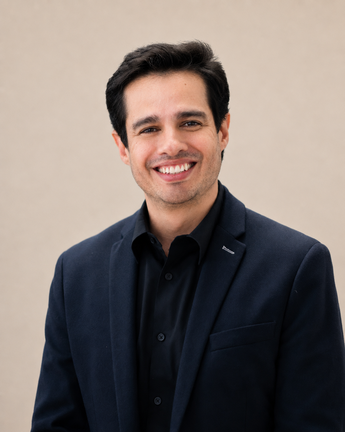 Luis Ballesteros wearing a navy jacket against a neutral background